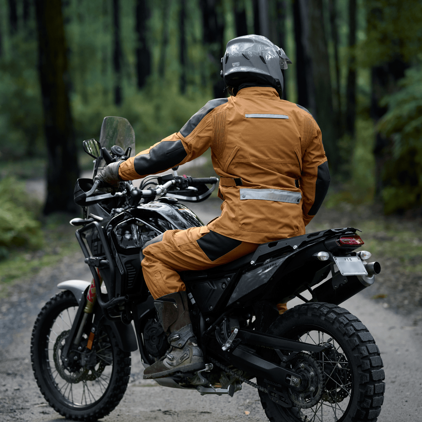 Person on a motorcycle in a forest setting