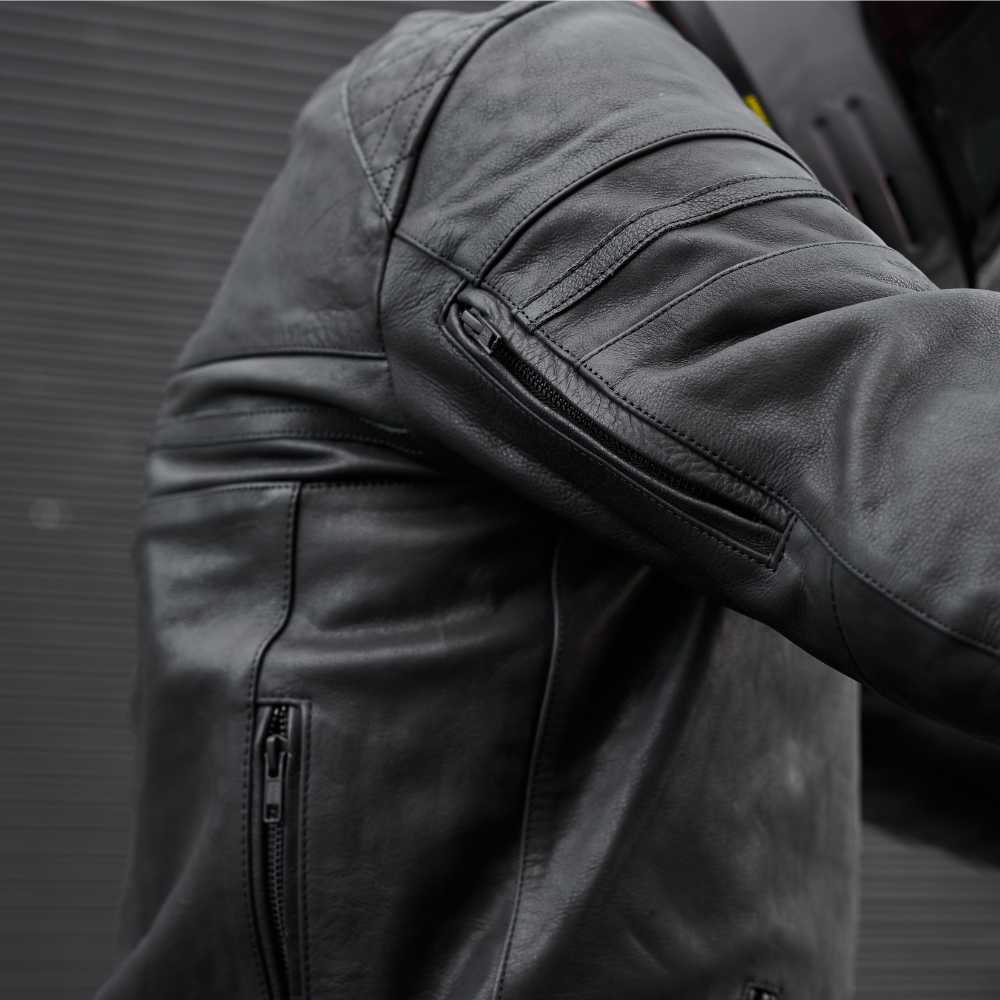 Close-up of a dark gray jacket with zippers on a blurred background